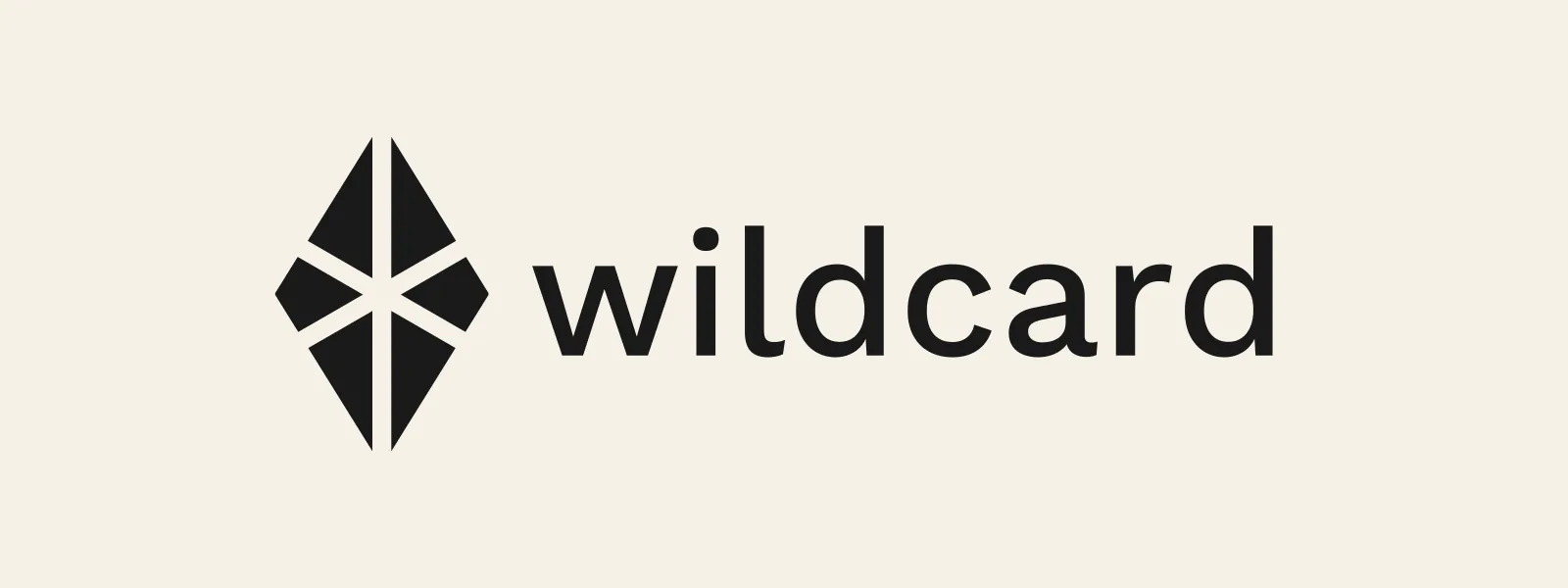 The locked @wildcard silhouette: a tall charcoal diamond cut into six shards by an asterisk whose arms run through its tips, with the lowercase wordmark wildcard beside it on cream.
